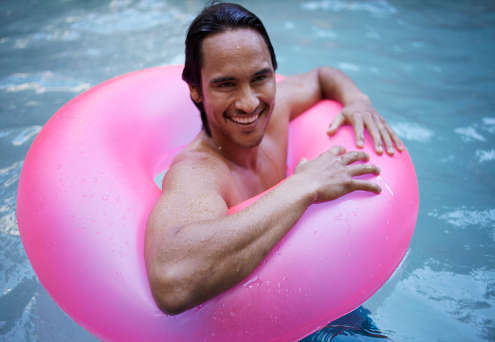 Man with inner tube in pool