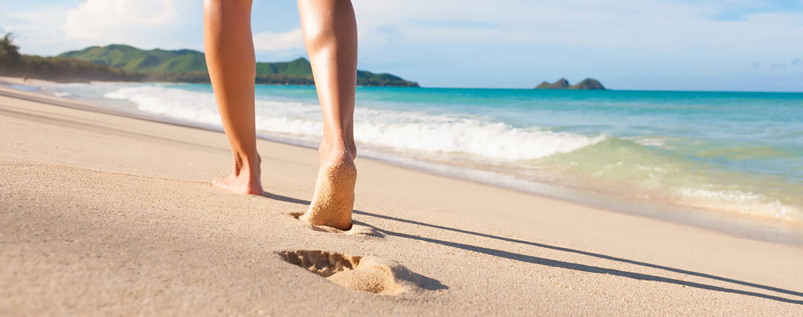 woman walking on sandy beach